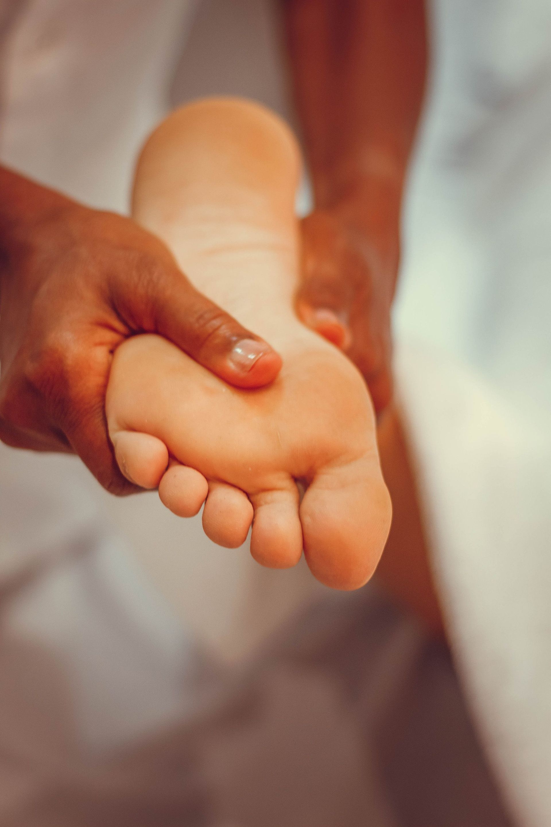 Close-up of therapeutic foot massage for relaxation and pampering in a spa setting.